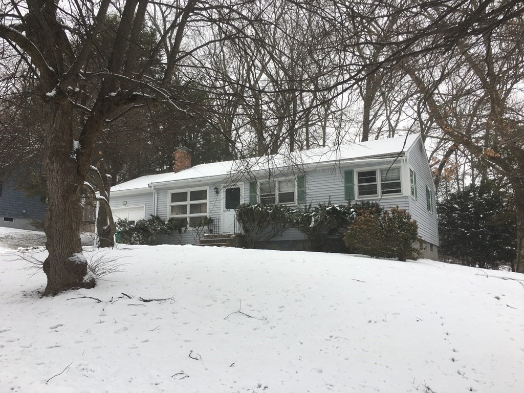 49 Indian Spring Road Ashland, MA 01721 - Photo 1 of 18 a front view of a house with a yard covered in snow