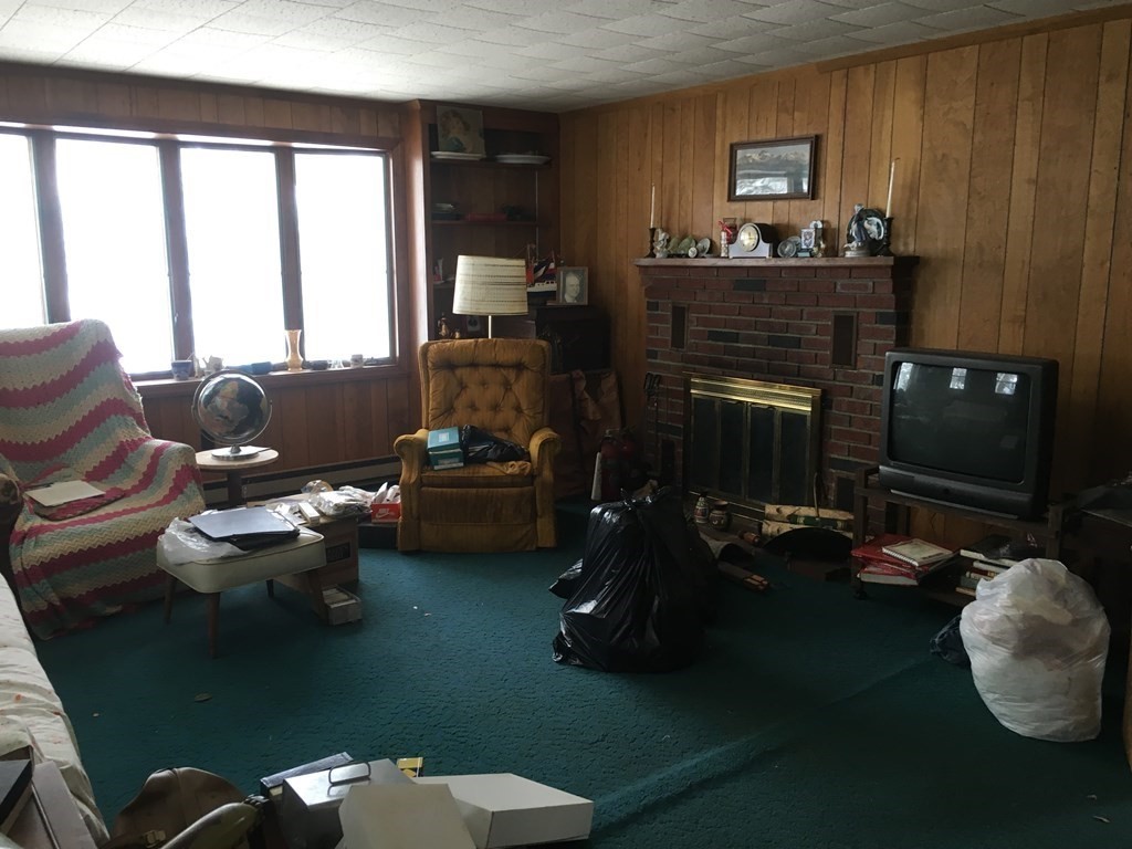 49 Indian Spring Road Ashland, MA 01721 - Photo 11 of 18 a living room with furniture and a fireplace