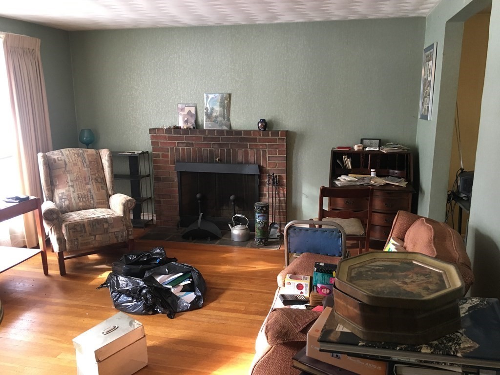 49 Indian Spring Road Ashland, MA 01721 - Photo 12 of 18 a living room with furniture and a fireplace