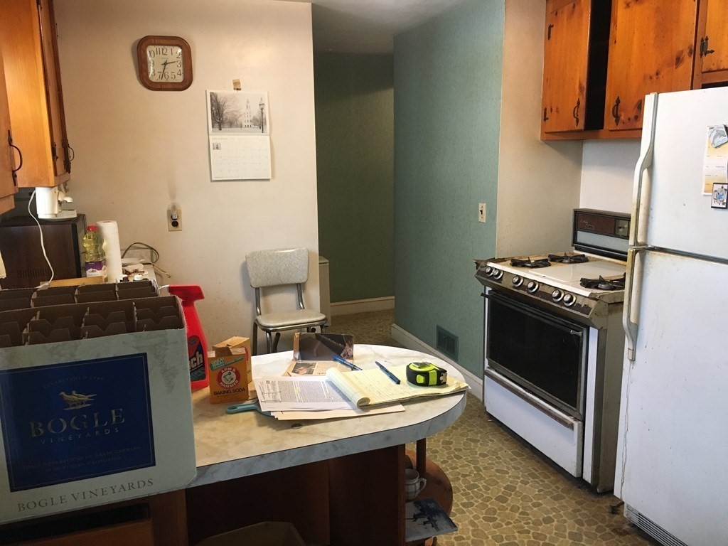 49 Indian Spring Road Ashland, MA 01721 - Photo 5 of 18 a kitchen with a stove and a refrigerator