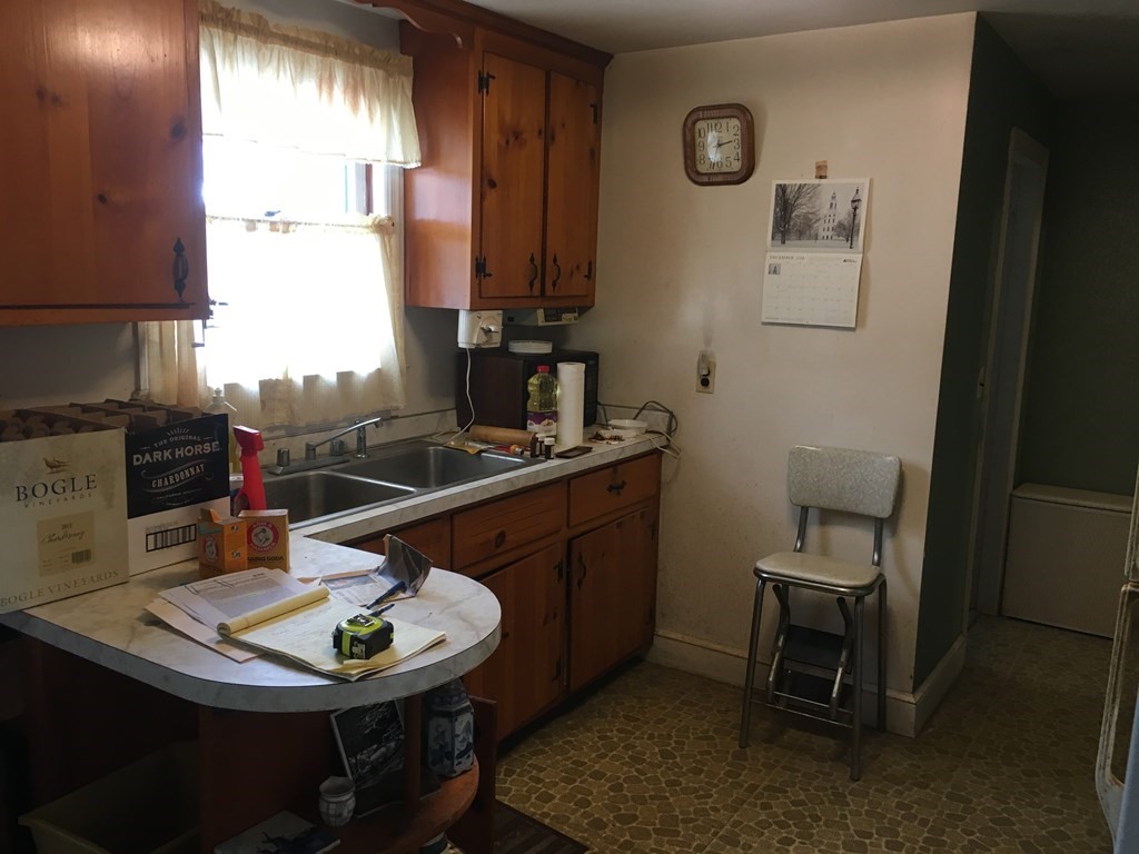49 Indian Spring Road Ashland, MA 01721 - Photo 7 of 18 a kitchen with a sink appliances and cabinets