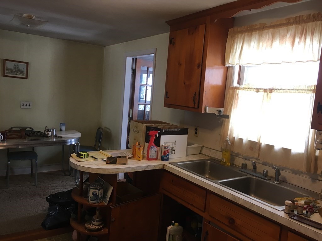 49 Indian Spring Road Ashland, MA 01721 - Photo 9 of 18 a kitchen with a sink cabinets and stove