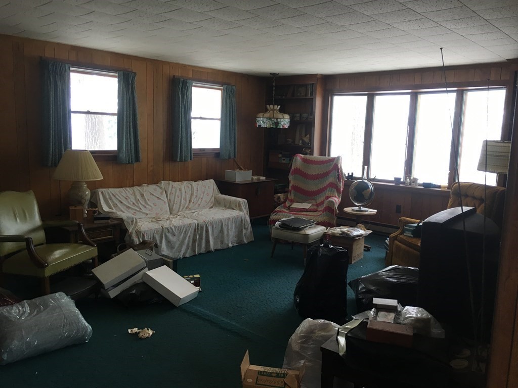 49 Indian Spring Road Ashland, MA 01721 - Photo 10 of 18 a living room with furniture and floor to ceiling windows