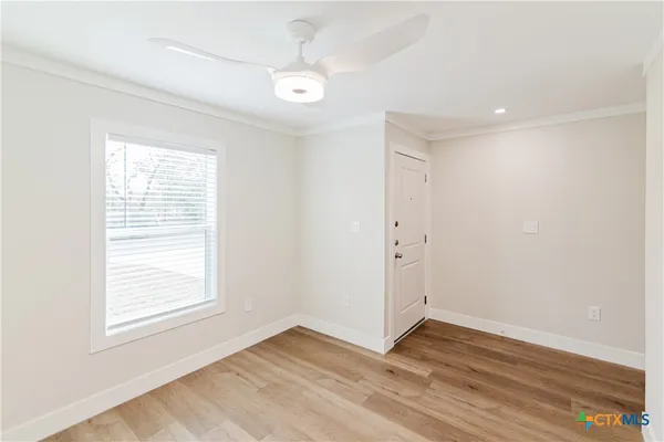 a view of a hallway with wooden floor