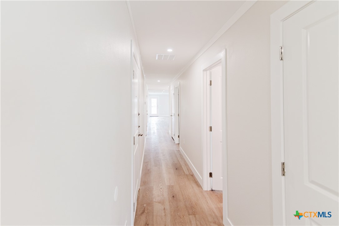 404 Bridge Street Cuero, TX 77954 - Photo 13 of 40 a view of a hallway with wooden floor