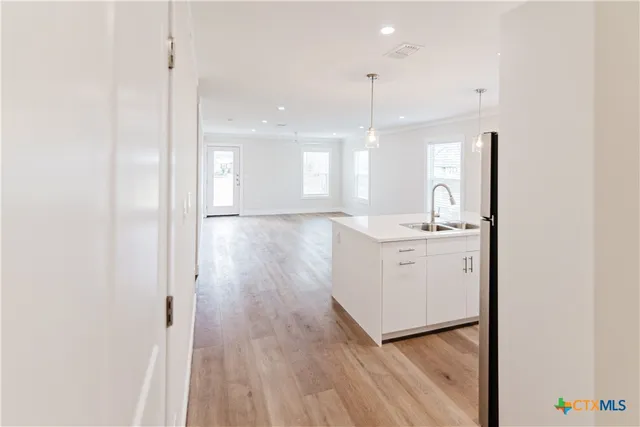 a view of a hallway with wooden floor