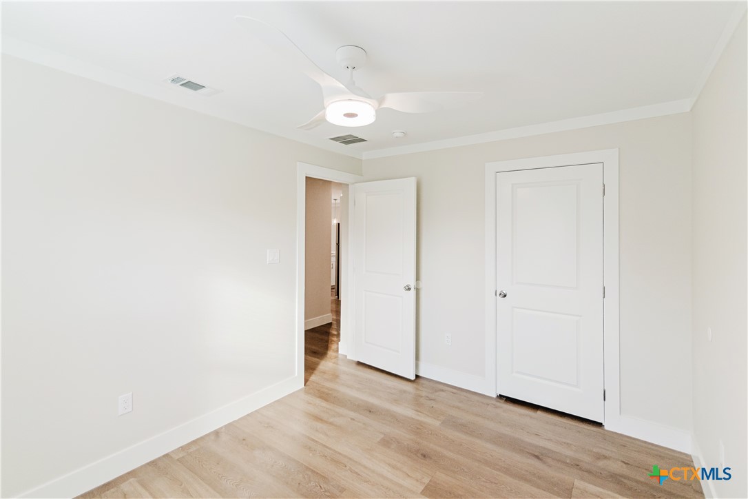 404 Bridge Street Cuero, TX 77954 - Photo 22 of 40 a view of an empty room with wooden floor