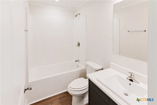 a bathroom with a sink toilet and vanity