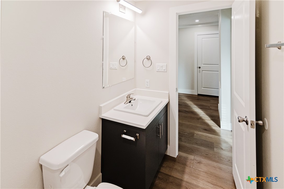 404 Bridge Street Cuero, TX 77954 - Photo 24 of 40 a bathroom with a sink toilet and vanity