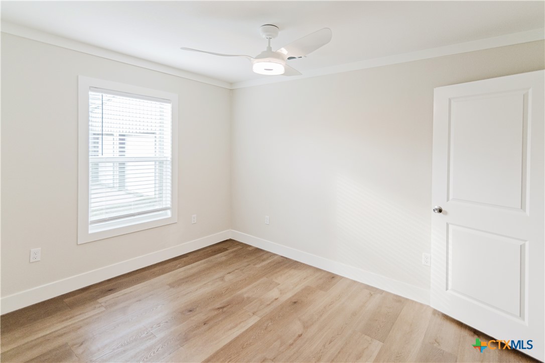 404 Bridge Street Cuero, TX 77954 - Photo 25 of 40 wooden floor in an empty room with a window