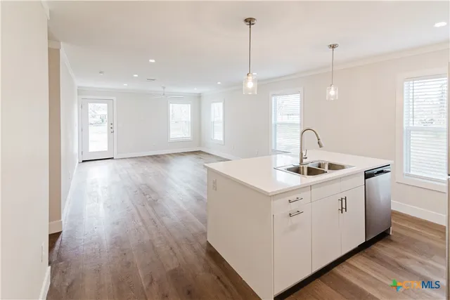 a kitchen with stainless steel appliances a refrigerator and a stove top oven