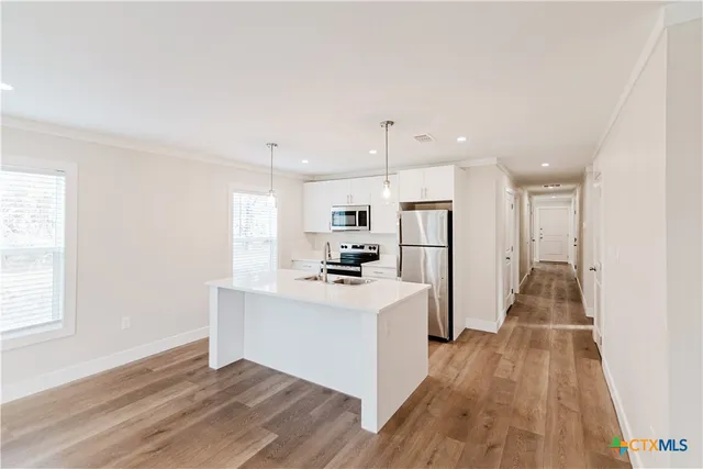 a view of kitchen with cabinets and wooden floor