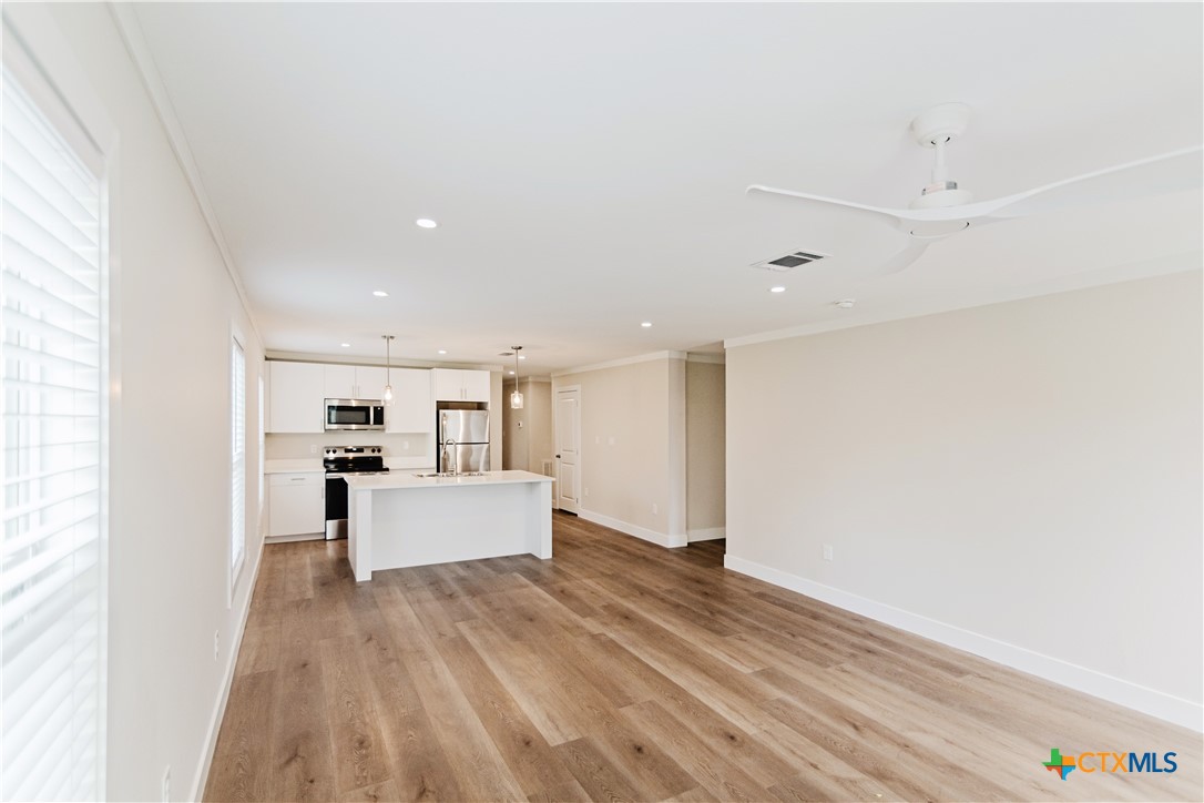 404 Bridge Street Cuero, TX 77954 - Photo 31 of 40 a view of kitchen with cabinets and wooden floor