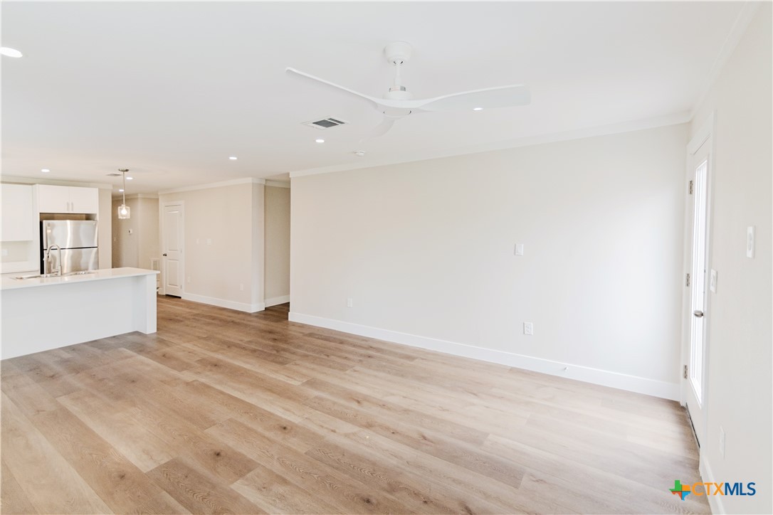 404 Bridge Street Cuero, TX 77954 - Photo 32 of 40 a view of an empty room with wooden floor