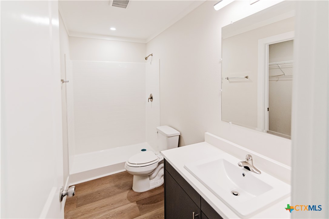 404 Bridge Street Cuero, TX 77954 - Photo 37 of 40 a bathroom with a sink toilet and shower