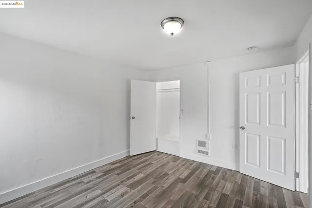 a view of an empty room and wooden floor
