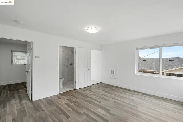 a view of wooden floor and windows in a room