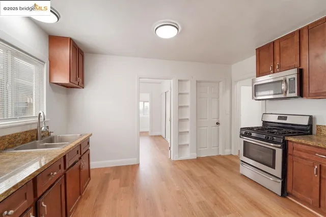a kitchen with stainless steel appliances granite countertop a stove and a sink