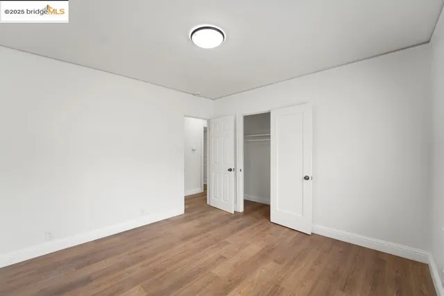 a view of a room with wooden floor