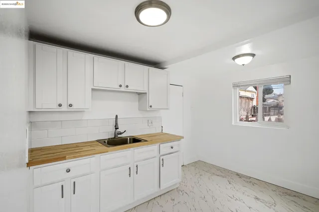 a kitchen with a sink and cabinets