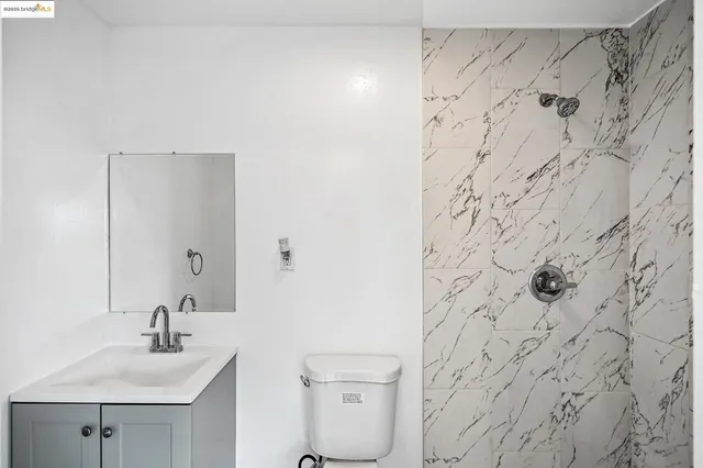 a bathroom with a sink and mirror with toilet