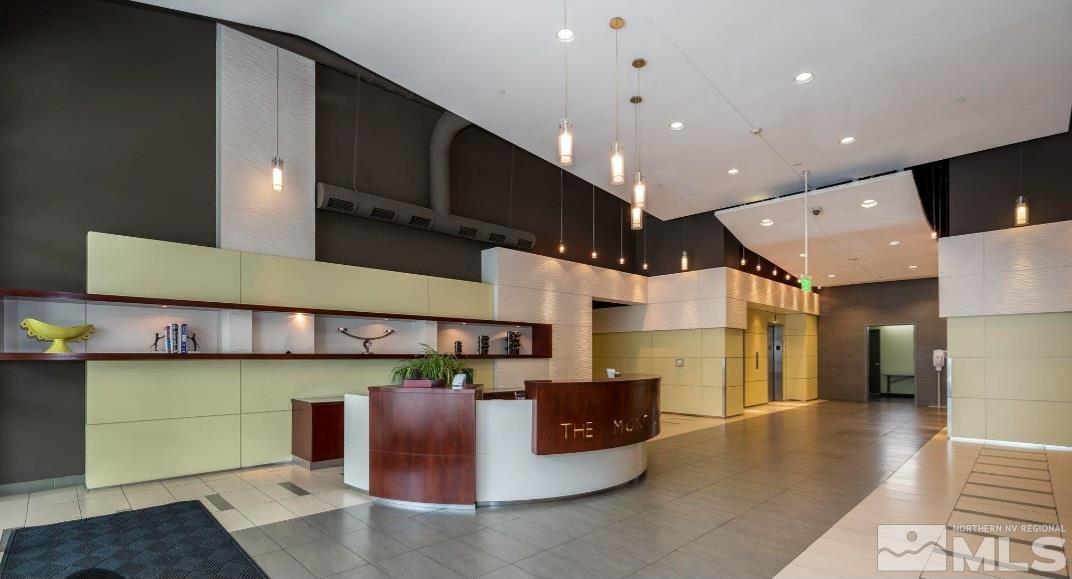 255 North Sierra Street, Unit 801 Reno, NV 89501 - Photo 14 of 32 a large kitchen with stainless steel appliances granite countertop a sink and cabinets