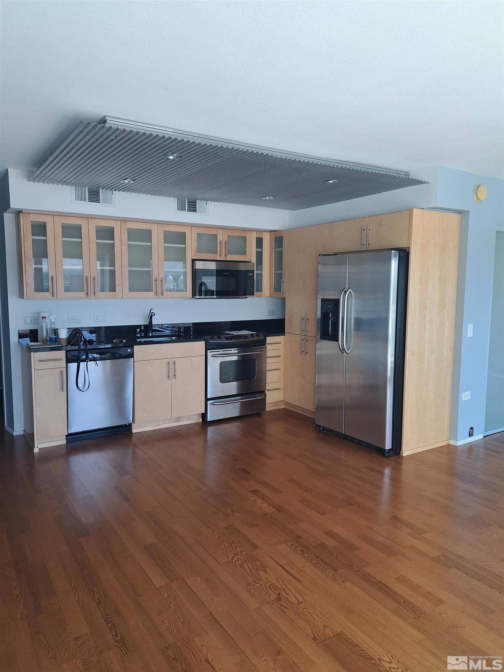 255 North Sierra Street, Unit 801 Reno, NV 89501 - Photo 3 of 32 a view of kitchen with granite countertop stainless steel appliances counter space and wooden floor