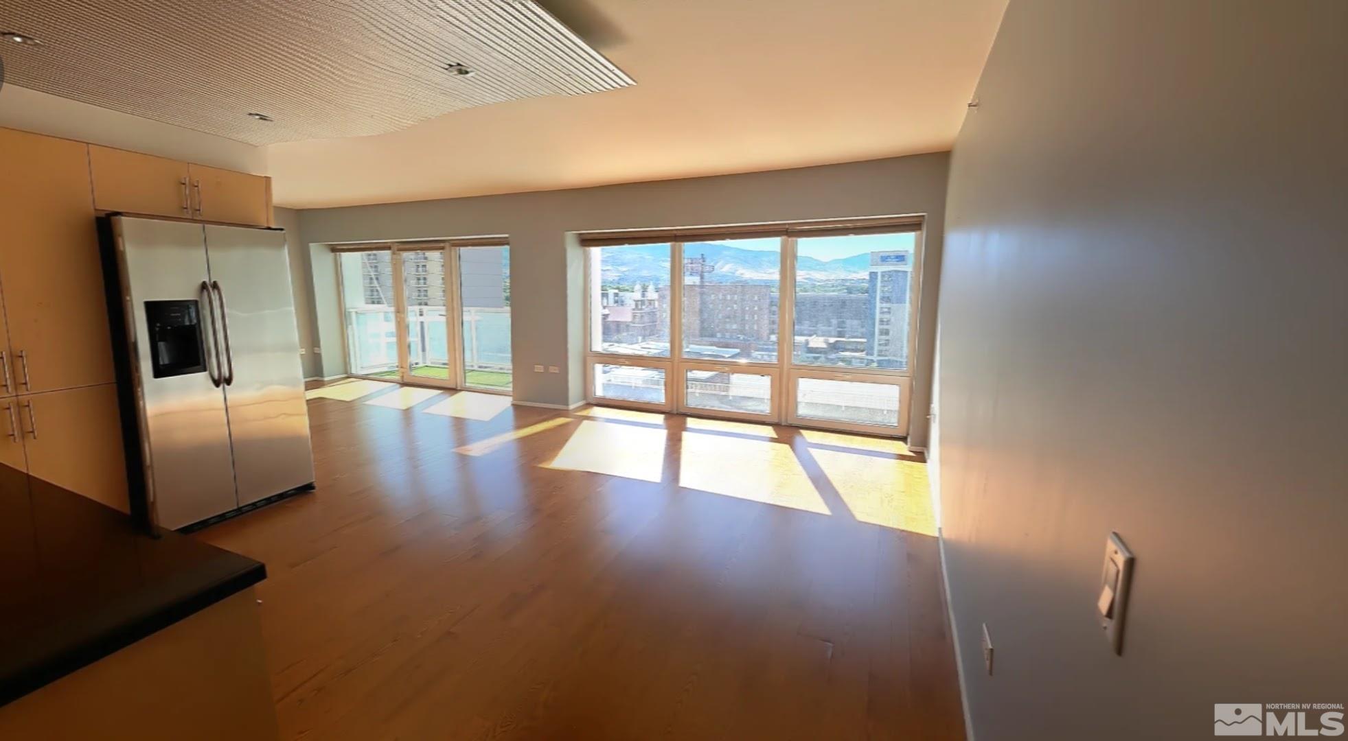255 North Sierra Street, Unit 801 Reno, NV 89501 - Photo 5 of 32 a view of a livingroom with furniture wooden floor and a floor to ceiling window
