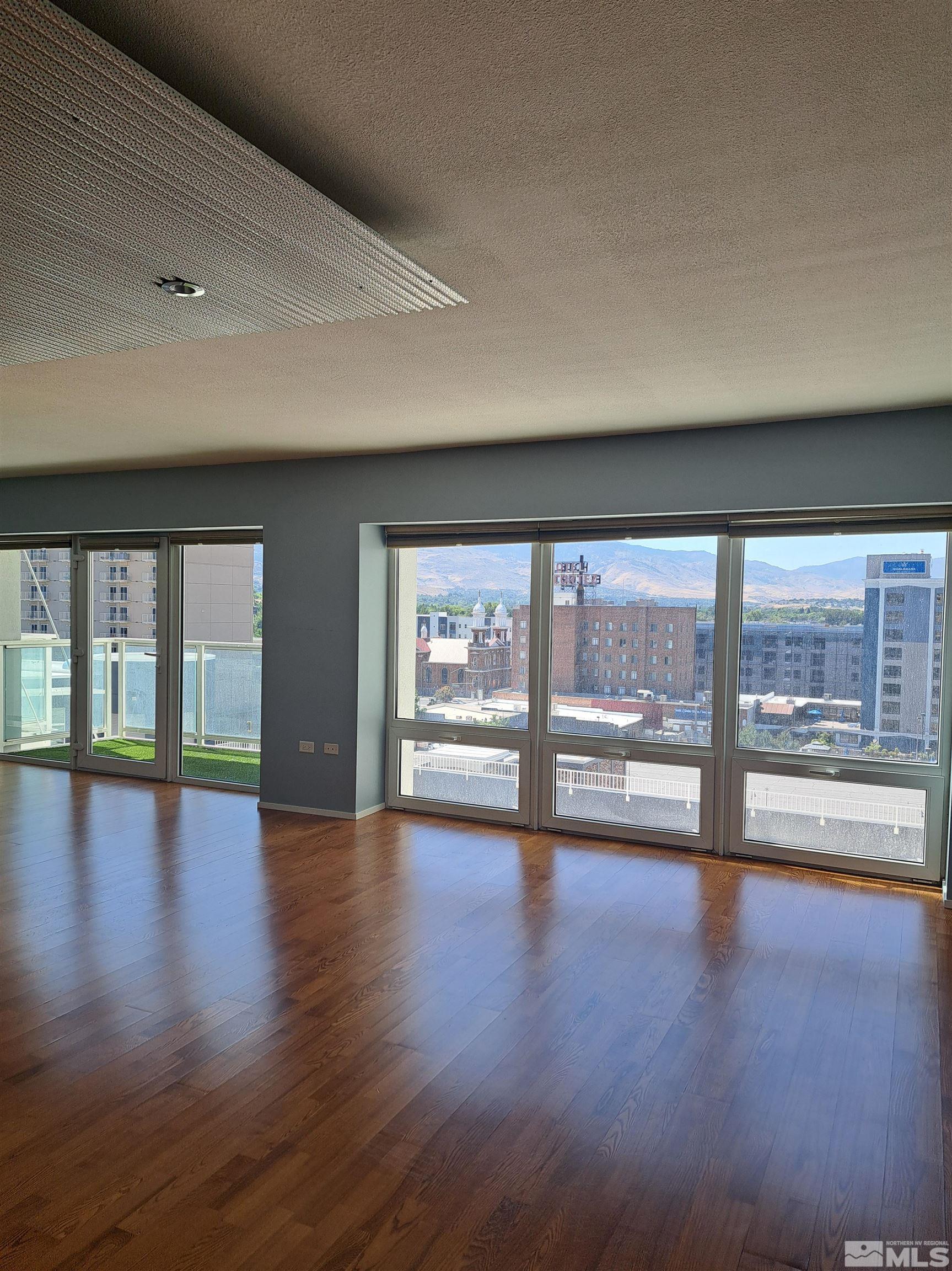 255 North Sierra Street, Unit 801 Reno, NV 89501 - Photo 6 of 32 a view of an empty room with wooden floor and a window