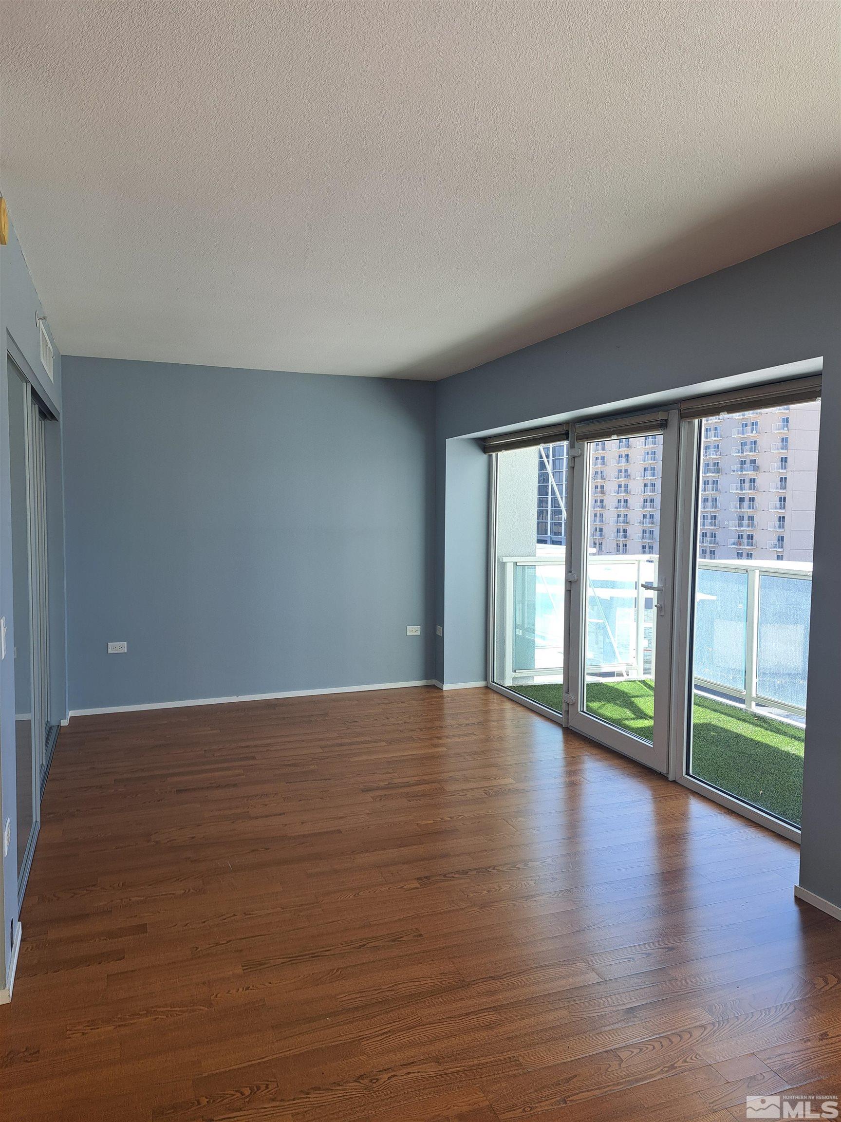 255 North Sierra Street, Unit 801 Reno, NV 89501 - Photo 9 of 32 a view of an empty room with wooden floor and a window