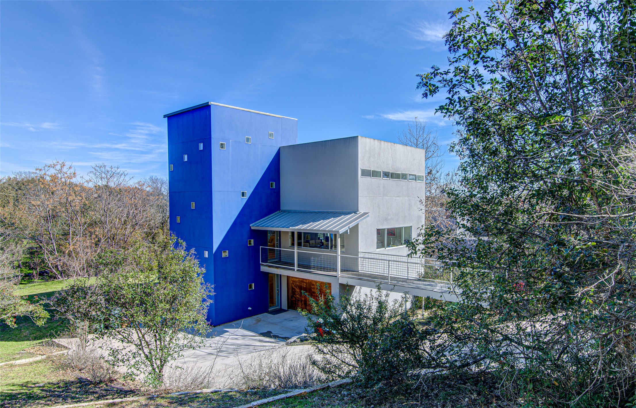 9707 Timber Ridge Pass Austin, TX 78733 - Photo 1 of 18 Bold geometric design defines this modern multi-level residence nestled among mature trees.