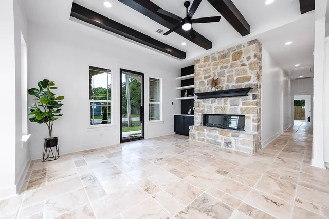 a view of a livingroom with a fireplace and window