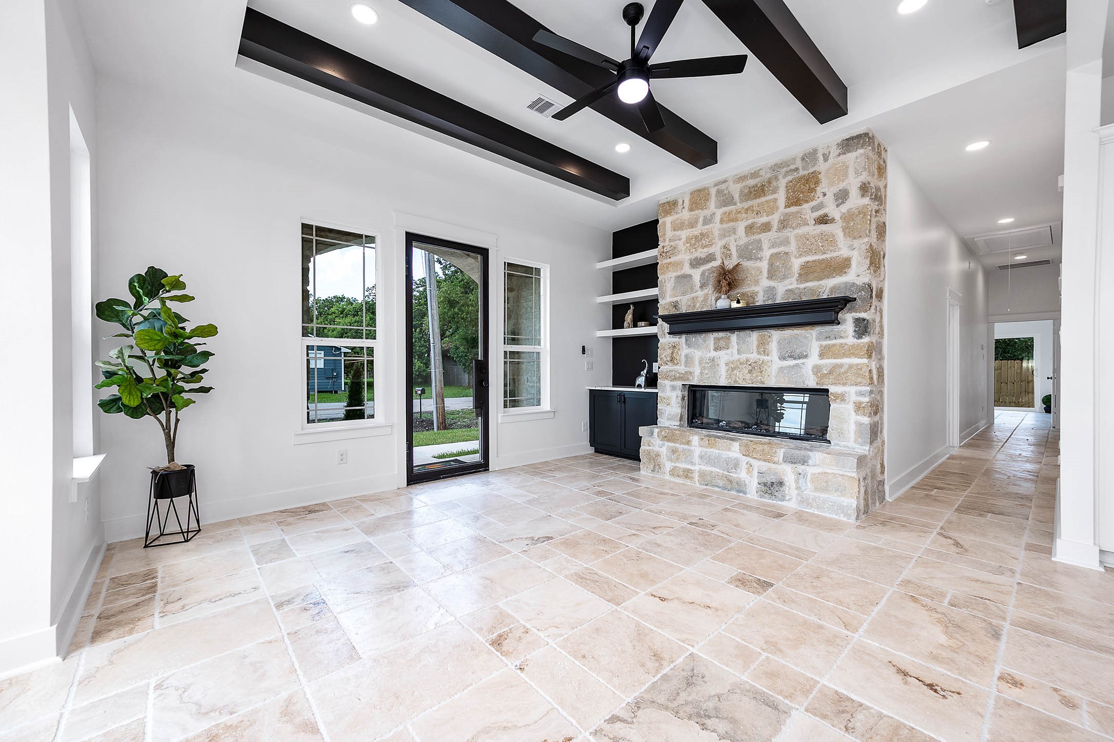 a view of a livingroom with a fireplace and window