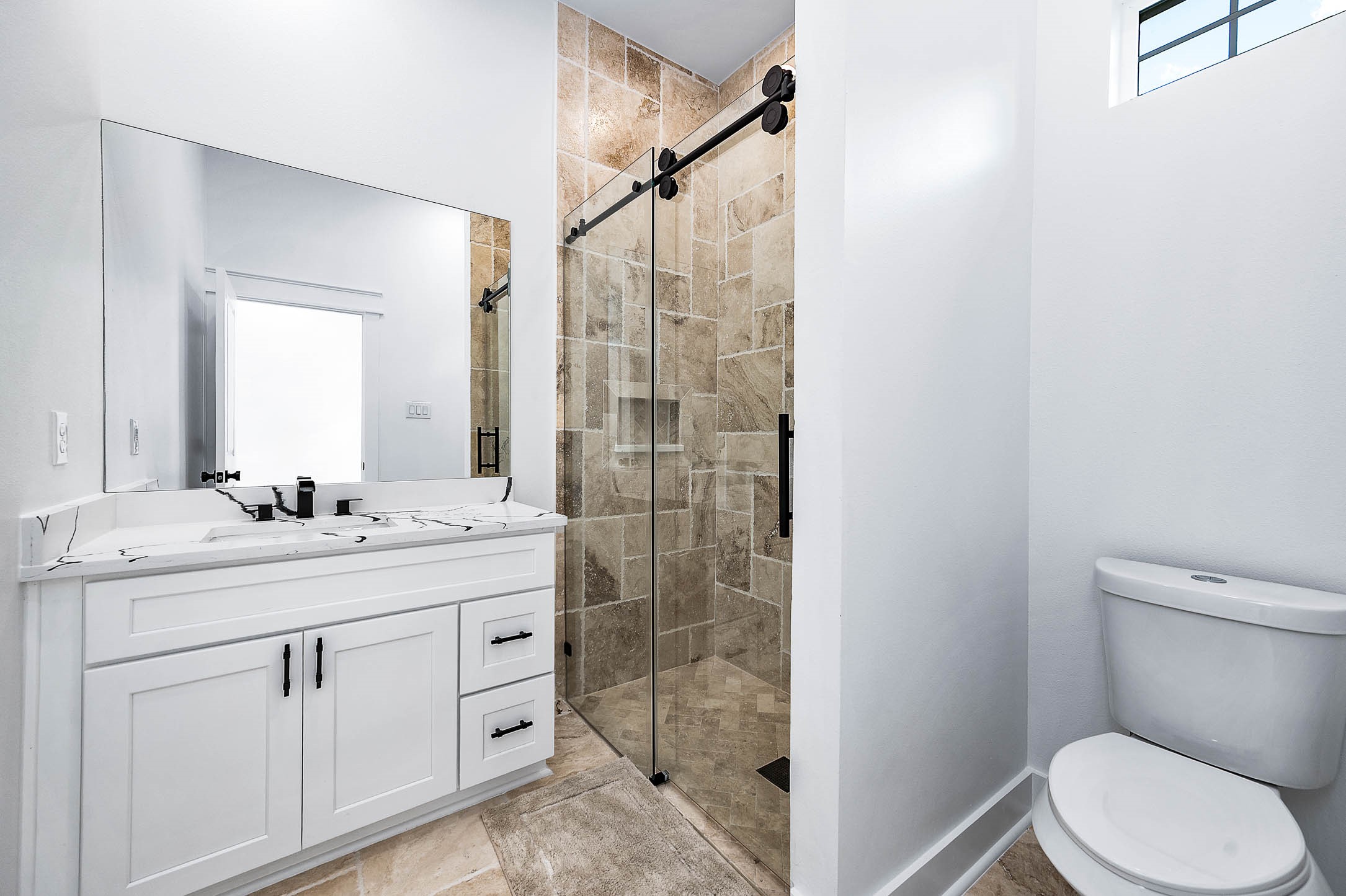 8903 Milby Street Needville, TX 77461 - Photo 18 of 32 a bathroom with a granite countertop sink a toilet and a mirror