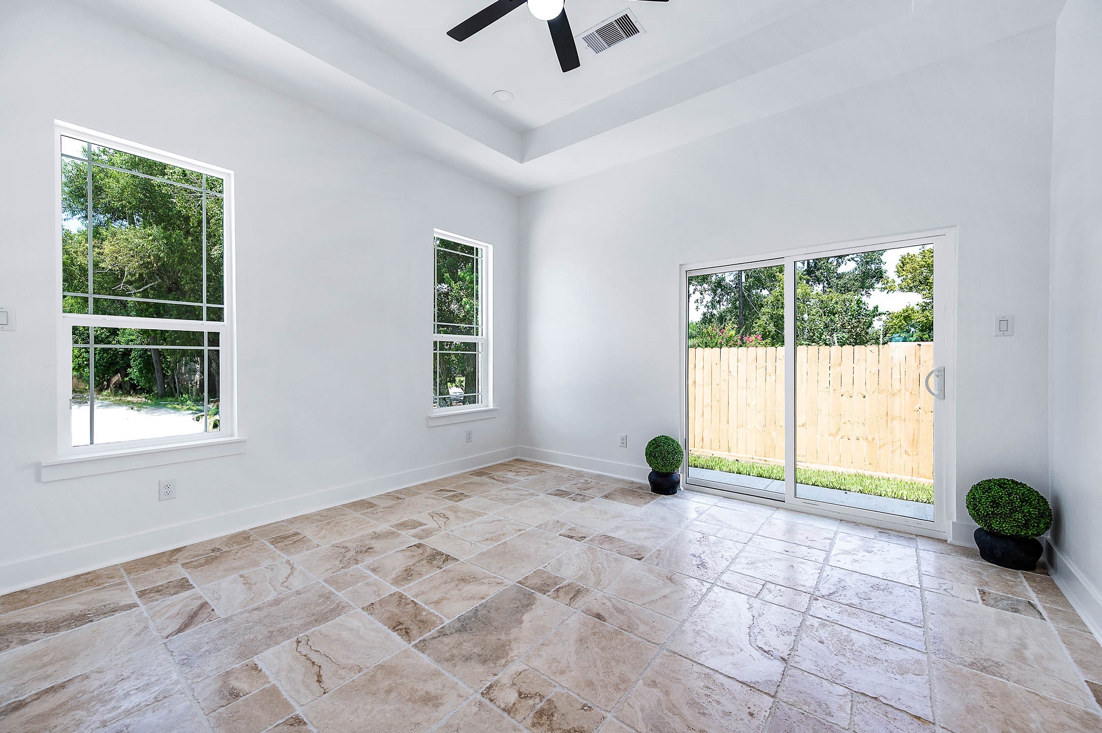 8903 Milby Street Needville, TX 77461 - Photo 21 of 32 a view of an empty room with a window and a ceiling fan