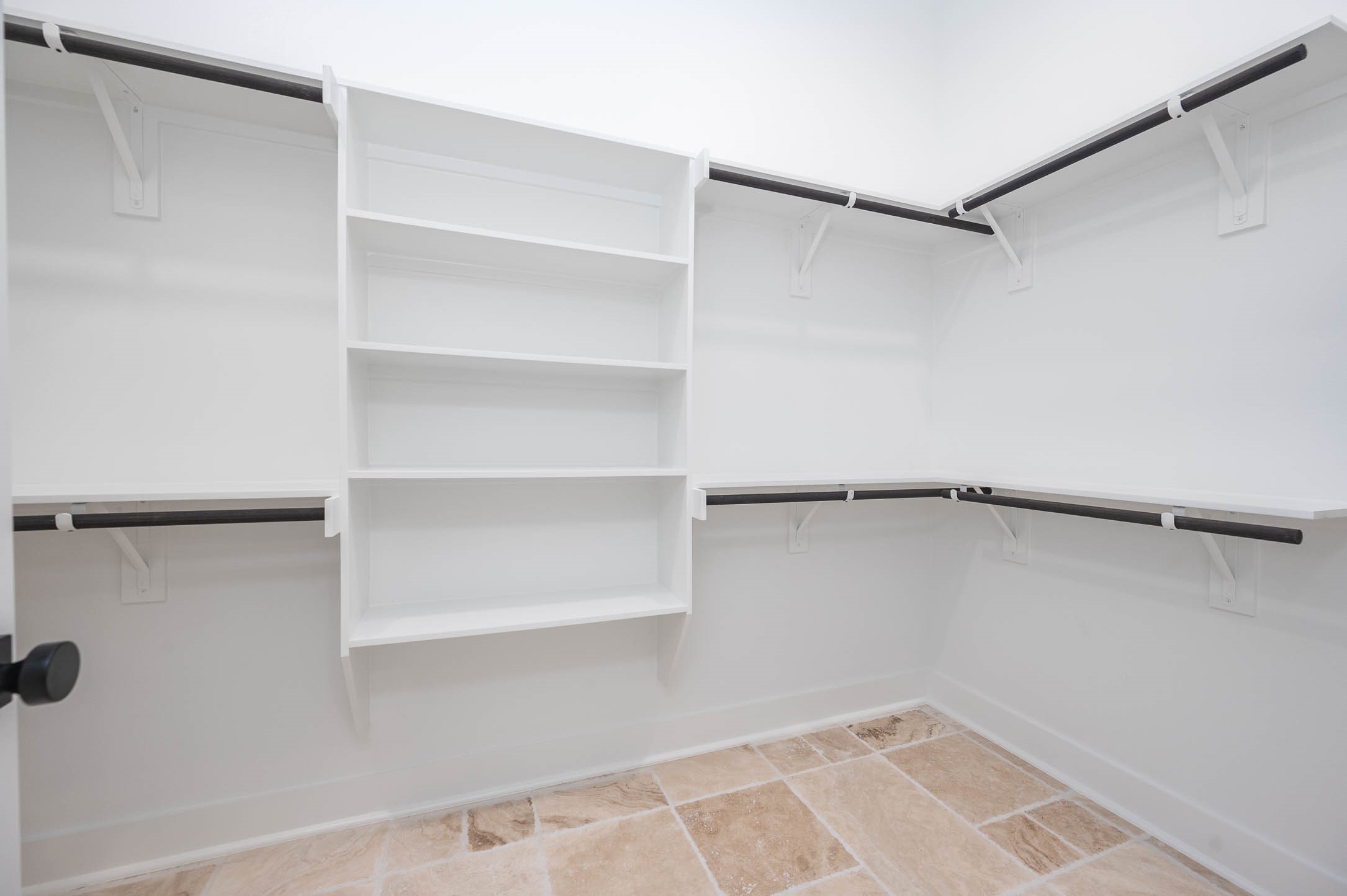 8903 Milby Street Needville, TX 77461 - Photo 25 of 32 a view of walk in closet with empty racks