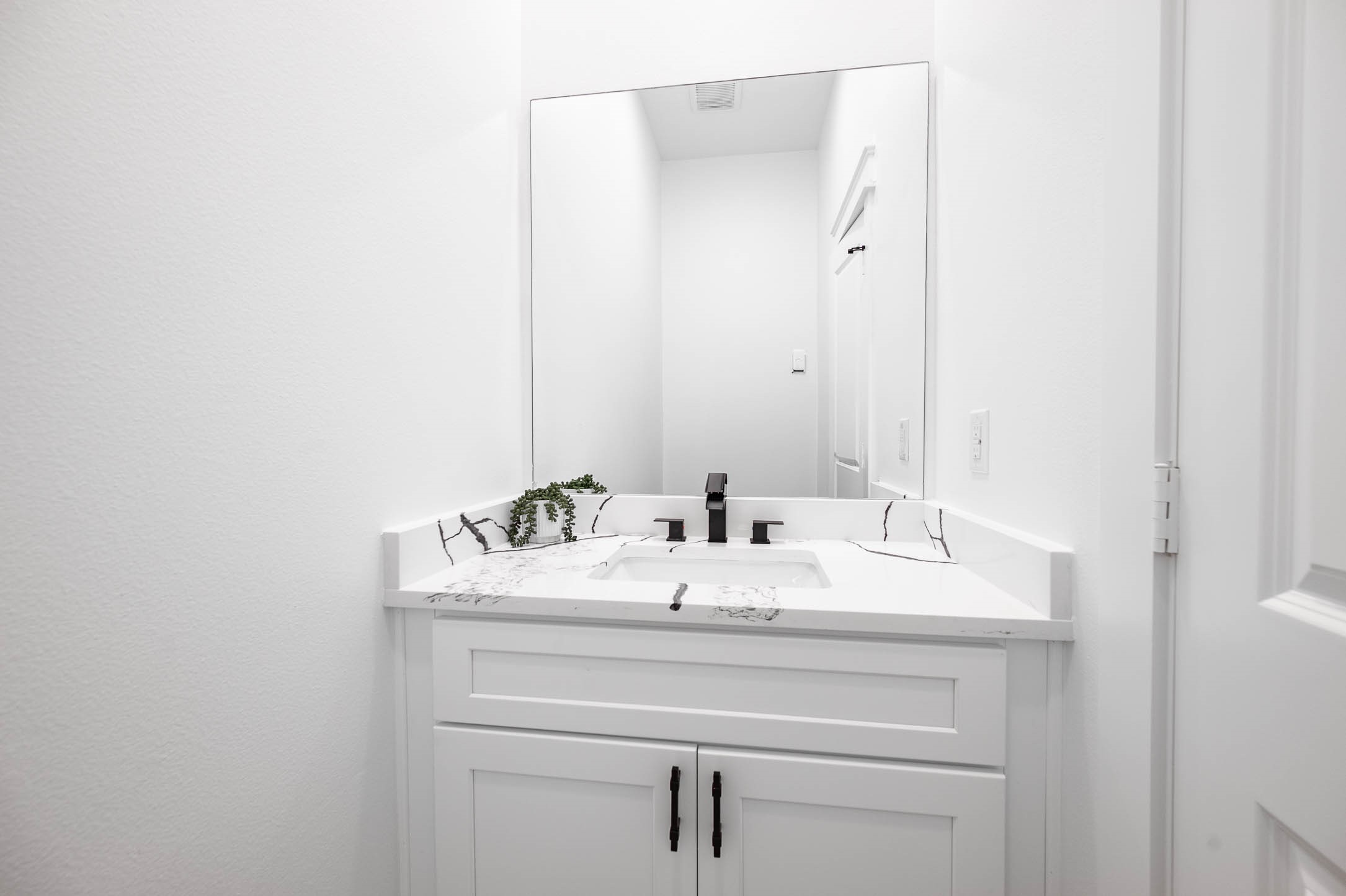 8903 Milby Street Needville, TX 77461 - Photo 27 of 32 a bathroom with a sink and a mirror