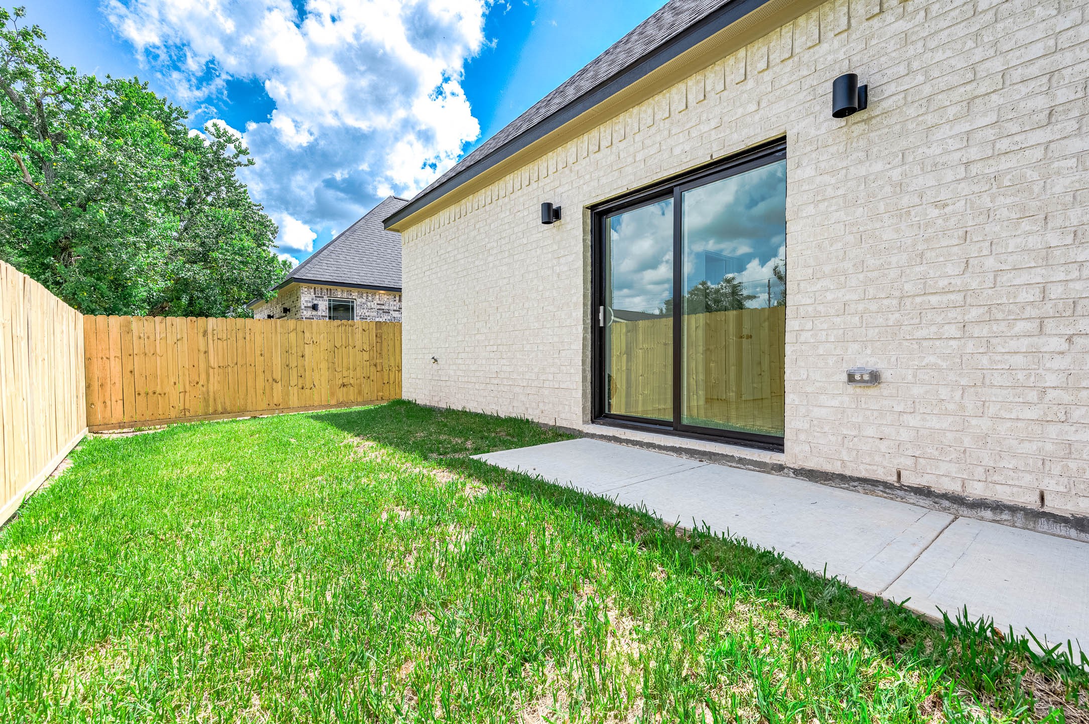 8903 Milby Street Needville, TX 77461 - Photo 29 of 32 a backyard of a house with seating space
