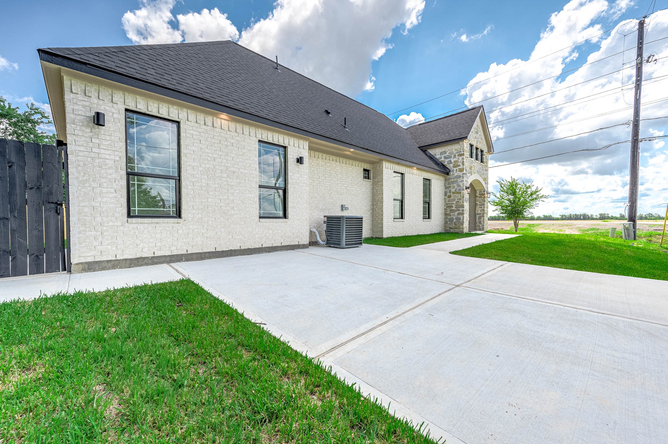 8903 Milby Street Needville, TX 77461 - Photo 4 of 32 a front view of a house with a yard and garage
