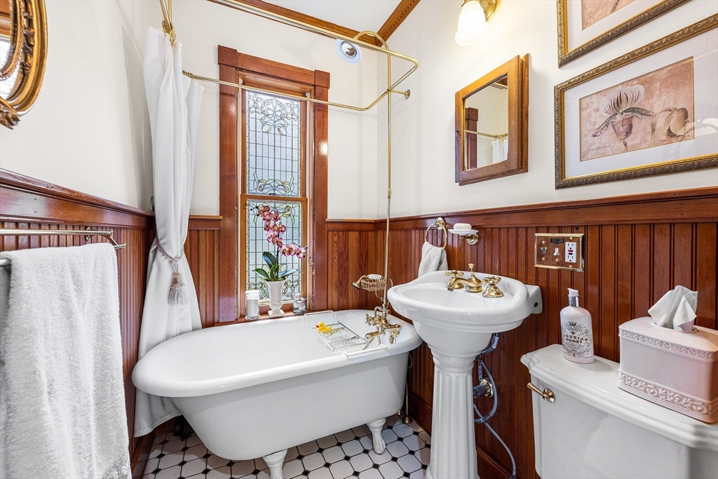 34 Cedar Street Wakefield, MA 01880 - Photo 13 of 33 a bathroom with a sink a mirror and a toilet