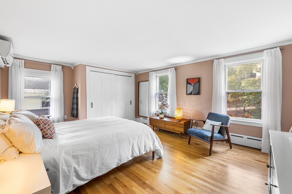 34 Cedar Street Wakefield, MA 01880 - Photo 17 of 33 a bedroom with a bed and a couch next to a window