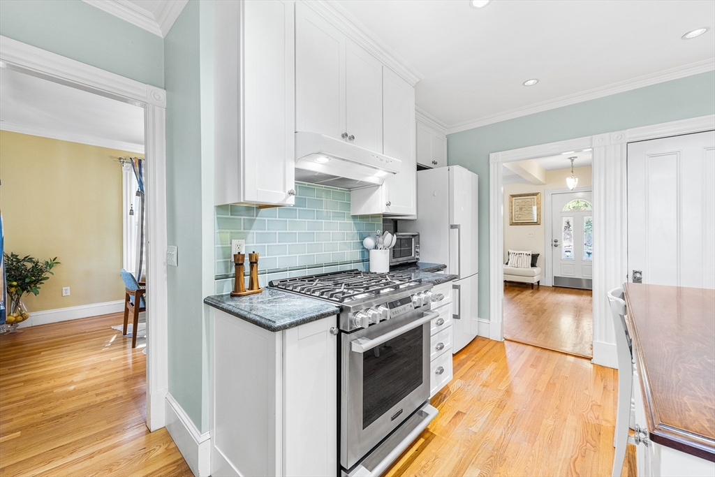 34 Cedar Street Wakefield, MA 01880 - Photo 9 of 33 a kitchen with stainless steel appliances granite countertop a stove and a refrigerator