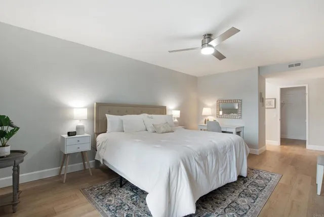 a bedroom with a bed and a lamp