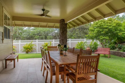 a view of an outdoor dining space with furniture and garden