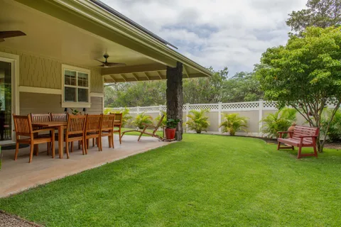 a view of a house with a backyard