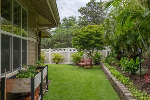 a view of house with backyard outdoor seating and hardwood
