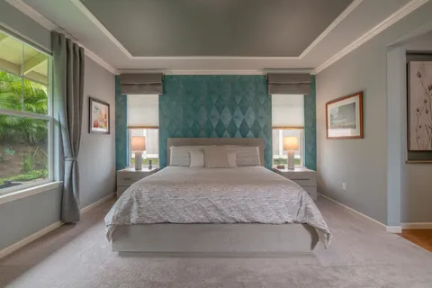 a spacious bedroom with a large bed and a large window