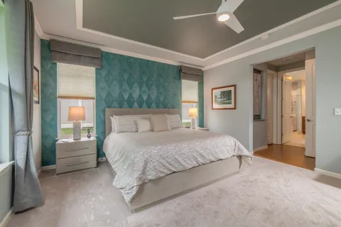 a spacious bedroom with a bed and a window