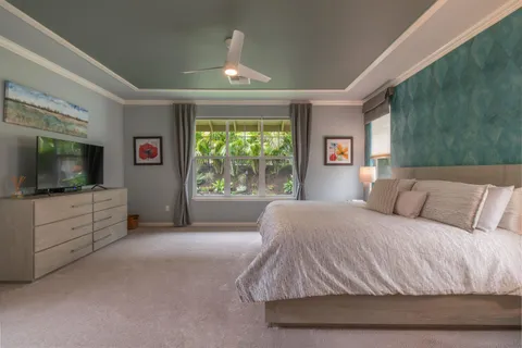 a bedroom with a large bed and a flat screen tv