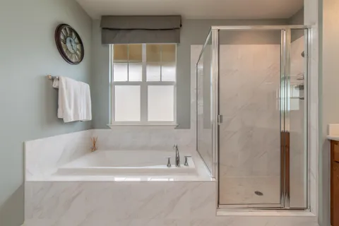 a white bath tub sitting next to a window